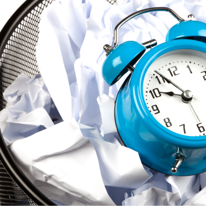 Time lost in everyday office life due to manual administration and lack of automation Alarm clocks in a wastepaper basket stand for time lost through manual processes and duplicated work.